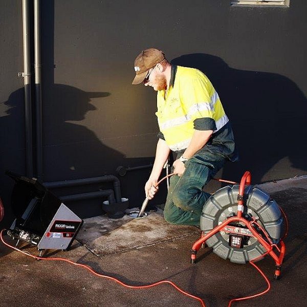 plumber with drain inspection camera